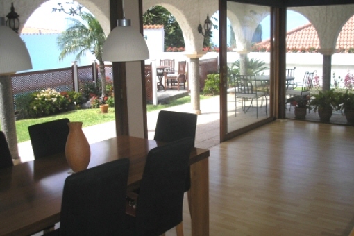 Spacious living and dining room with views to colonnade and garden