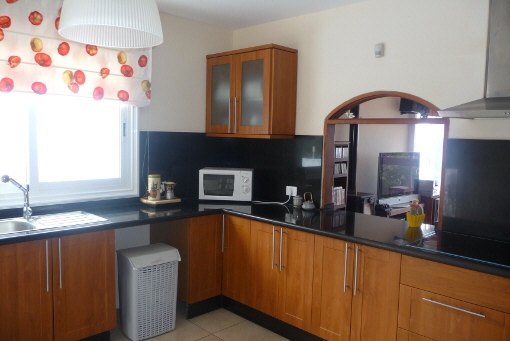 Large kitchen with serving hatch and dining area