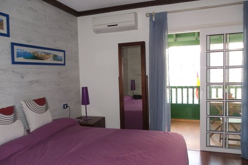 Large bedroom with balcony and air conditioning