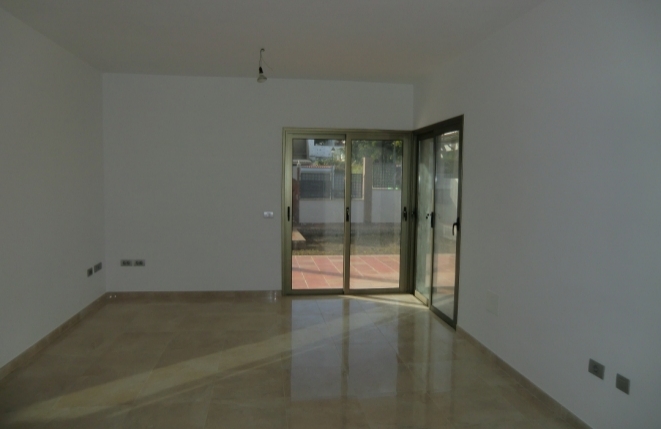 Living room with access to the terrace and garden