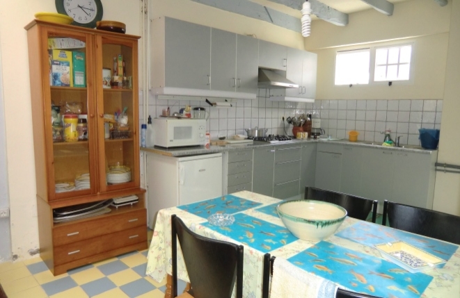 Open kitchen with further dining area