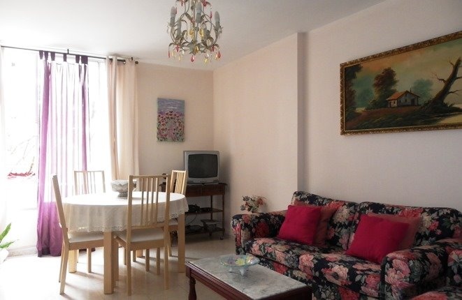 Spacious living room with dining area and large windows