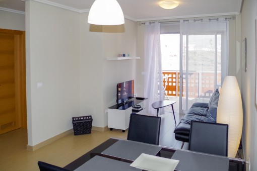 Living and dining area with balcony access